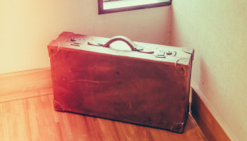 Photo of a brown vintage suitcase.