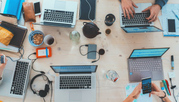 Laptops on a shared desk 